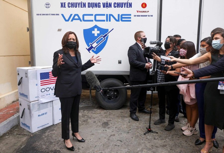 US Vice President Kamala Harris speaks with the media as she visits the National Institute of Hygiene and Epidemiology (NIHE) where 270,000 doses of Pfizer vaccine arrived earlier in the morning, in Hanoi, Vietnam, 26 August 2021. (Evelyn Hockstein/AFP)