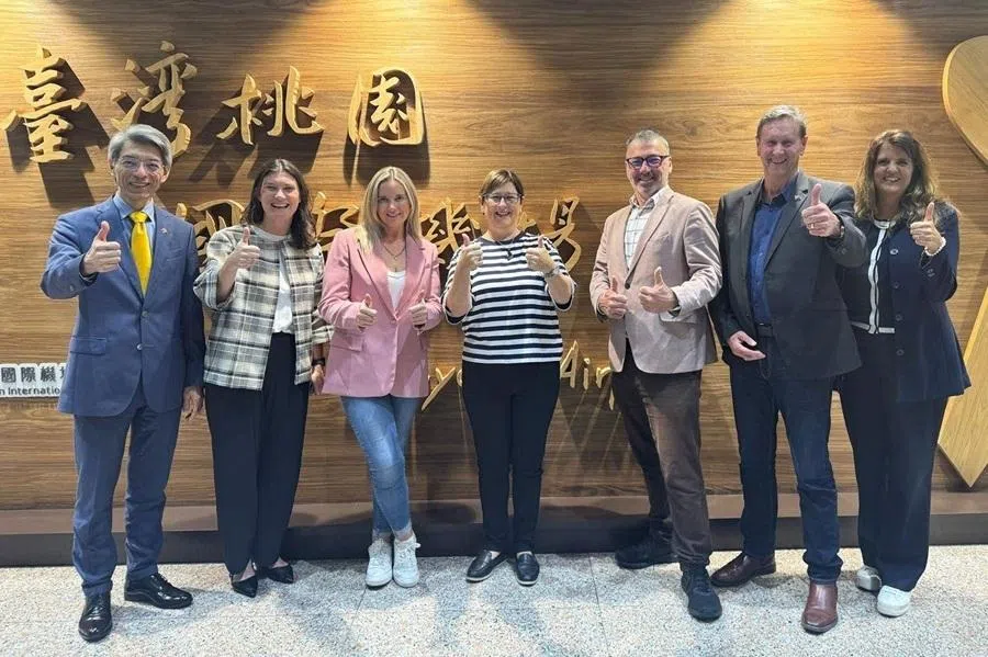 This handout photo taken on 4 May 2026 from Taiwan's Ministry of Foreign Affairs shows New Zealand lawmakers Maureen Pugh (centre), Duncan Webb (third from right), Laura McClure (third from left) and David Wilson (second from right) posing for a group photo at Taiwan Taoyuan International Airport in Taoyuan.