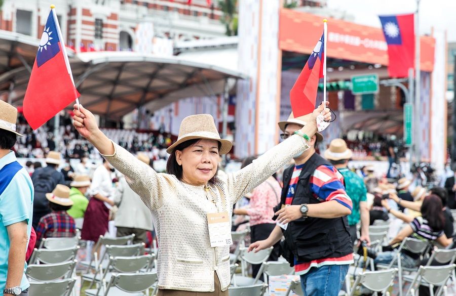 An attendee holds Taiwan flags during National Day celebrations in Taipei, Taiwan, 10 October 2020. (I-Hwa Cheng/Bloomberg)