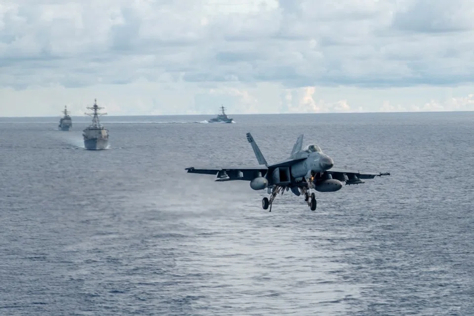 An F/A-18E Super Hornet, attached to the Dambusters of Strike Fighter Squadron (VFA) 195, approaches the flight deck of the Navy's forward-deployed aircraft carrier USS Ronald Reagan (CVN 76) during a drill in the South China Sea, 6 July 2020. (MC2 Samantha Jetzer/Handout/US Navy)