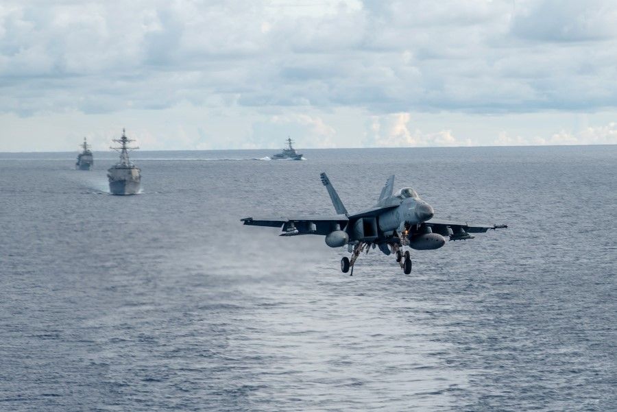 An F/A-18E Super Hornet, attached to the Dambusters of Strike Fighter Squadron (VFA) 195, approaches the flight deck of the Navy's forward-deployed aircraft carrier USS Ronald Reagan (CVN 76) during a drill in the South China Sea, 6 July 2020. (MC2 Samantha Jetzer/Handout/US Navy)