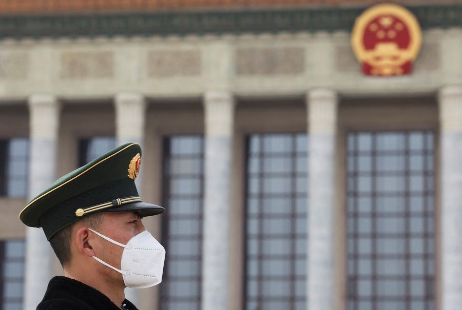 A paramilitary police officer stands guard outside the Great Hall of the People in Beijing, China, 13 March 2023. (Florence Lo/Reuters)