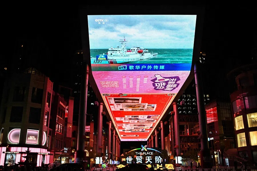 This picture shows a general view of a public big screen broadcasting news about China’s military drills around Taiwan, outside a shopping mall in Beijing on 1 April 2025.  (Adek Berry/AFP)