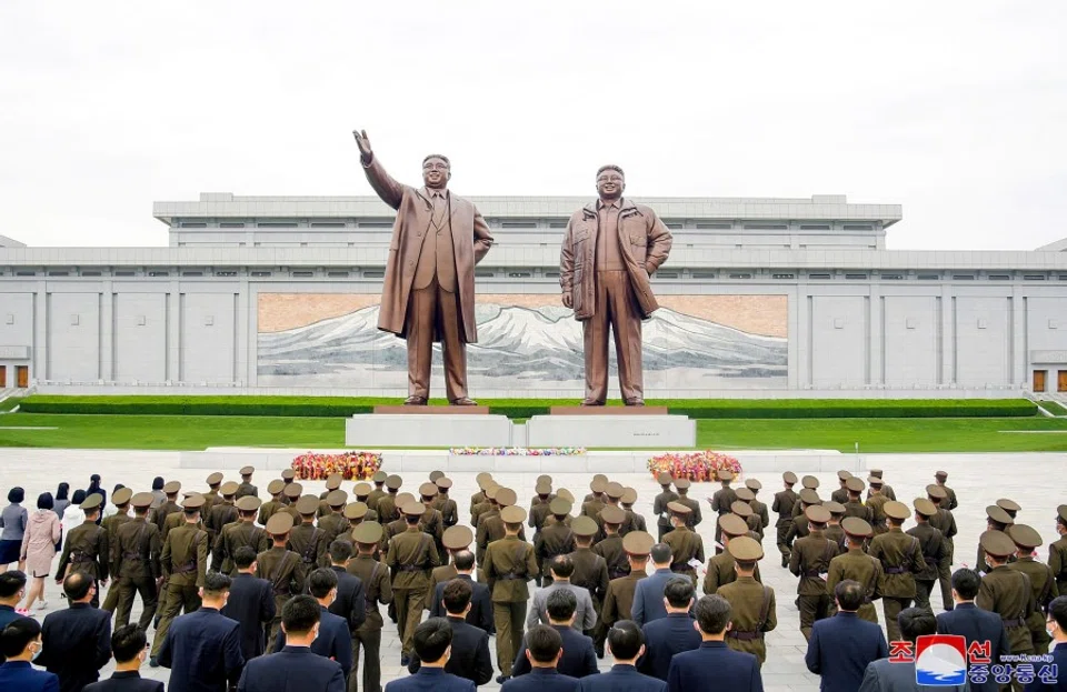 This picture taken on 25 April 2023 and released by North Korea's official Korean Central News Agency (KCNA) on 26 April hows soldiers and civilians offering attending a wreath-laying ceremony at the bronze statues of Kim Il Sung and Kim Jong Il on Mansudae Hill in Pyongyang to mark the 91st founding anniversary of the Korean People's Revolutionary Army (KPRA). (KCNA via KNS/AFP)