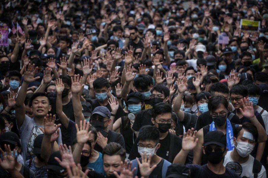 Protesters in Hong Kong hold up their hands to symbolise their five demands. (AFP)