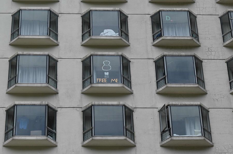This picture shows messages posted on windows by quarantined guests at a hotel in Hong Kong on 26 September 2021. (Peter Parks/AFP)