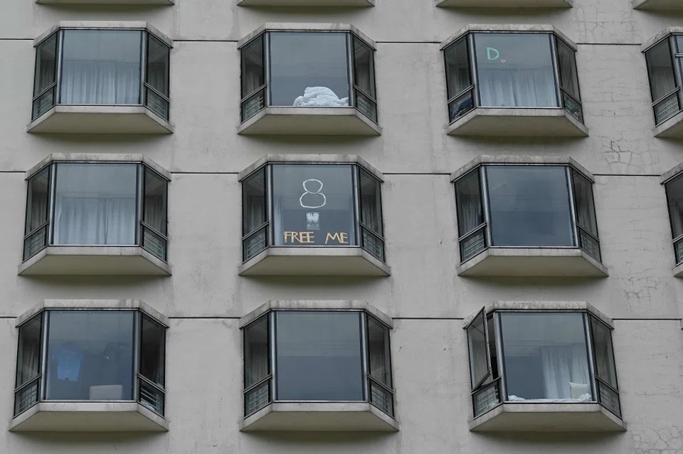 This picture shows messages posted on windows by quarantined guests at a hotel in Hong Kong on 26 September 2021. (Peter Parks/AFP)