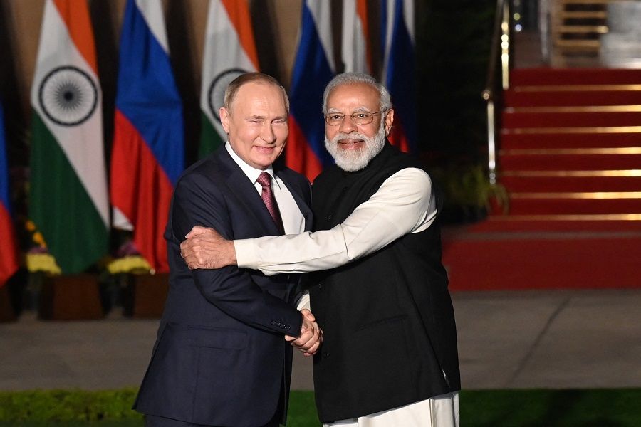 India's Prime Minister Narendra Modi (right) greets Russian President Vladimir Putin before a meeting at Hyderabad House in New Delhi, India, on 6 December 2021. (Money Sharma/AFP)