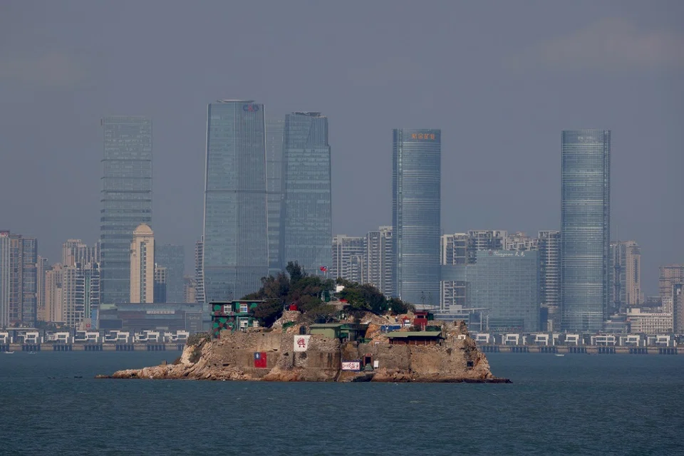 A Taiwan flag is seen painted on Shihyu Islet in front of Xiamen, a coastal city in China, in Lieyu Township, Kinmen, Taiwan, 19 October 2021. (Ann Wang/Reuters)