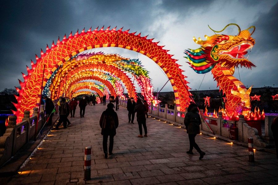This photo taken on 15 February 2022 shows people visiting a lantern show during the Lantern Festival in Yantai in China's eastern Shandong province. (AFP)