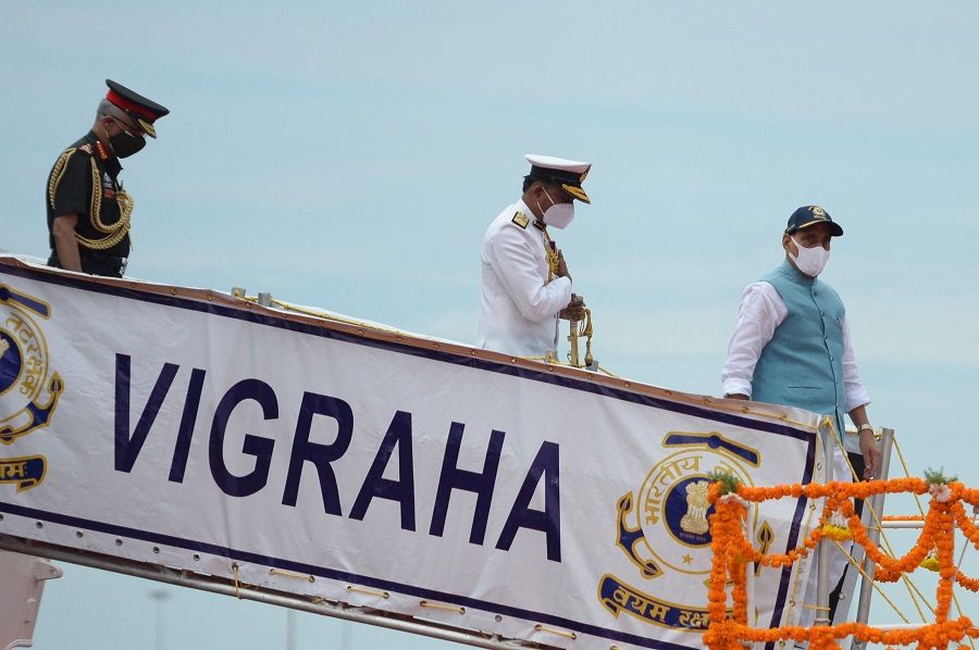 Indian Defence Minister Rajnath Singh (right) looks on as he walks during the commissioning ceremony of the Indian Coast Guard offshore patrol vessel 'VIGRAHA' in Chennai, India, on 28 August 2021. (Arun Sankar/AFP)