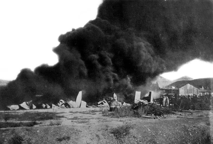 August 1904: Thick black smoke rises following an enormous explosion as the Japanese hit a Russian munitions bunker in Port Arthur. On 19 August, the Japanese attacked Port Arthur with the support of 300 cannons. The First Division formed the right wing attacking western highlands such as Mount Dadingzi and 203 Hill, while the Ninth Division attacked the Songshushan (Pine Tree Hill) battery and the north Longyan battery; the 11th Division formed the left wing attacking the north Jiguanshan (Cockscomb Hill) battery and east Longshan (Dragon Hill) battery. The battles were fierce, with the Japanese filling the air with screams as they rushed towards the heavy Russian artillery. The Japanese lost 15,000 men, about a quarter of the Third Army, but failed to take the area.