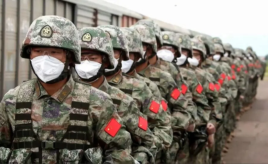 This screen grab obtained from a handout video released by the Russian Defence Ministry on August 29, 2022, shows Chinese soldiers marching along a railway platform upon their arrival for 'Vostok-2022' military exercises at the Sergeevsky training ground at Primorskiy (Maritime) Kray of the Russian Far East. (Handout/Russian Defence Ministry/AFP)