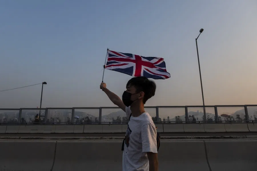 A demonstrator waves a Union Jack during a protest in Hong Kong. The people of Hong Kong seem to no longer consider mainland China family. (Chan Long Hei/Bloomberg)