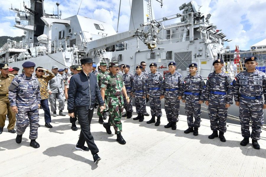 In this 8 January 2020, file photo released by the Indonesian Presidential Office, Indonesian President Joko Widodo, center, inspects troops during his visit at Indonesian Navy ship KRI Usman Harun at Selat Lampa Port, Natuna Islands, Indonesia. Widodo reaffirmed his country's sovereignty during a visit to a group of islands at the edge of the South China Sea that China claims as its traditional fishing area. (Agus Soeparto, Indonesian Presidential Office)