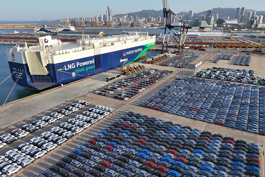 Cars and other vehicles wait to be loaded onto a ship at Yantai Port, in China’s eastern Shandong province on 22 March 2025. (AFP)