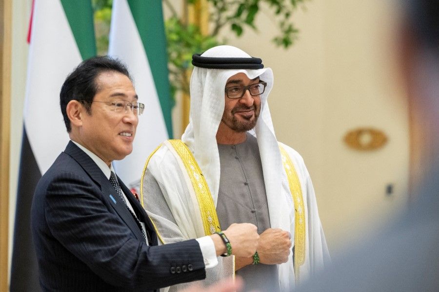 Sheikh Mohamed bin Zayed Al Nahyan, President of the United Arab Emirates (right), and Fumio Kishida, Prime Minister of Japan (left), stand for a photograph wearing a 2023 UN Climate Change Conference (Cop 28) wristbands during an official reception, at Qasr Al Watan, Abu Dhabi, United Arab Emirates, 17 July 2023. (Mohamed Al Hammadi/UAE Presidential Court/Handout via Reuters)
