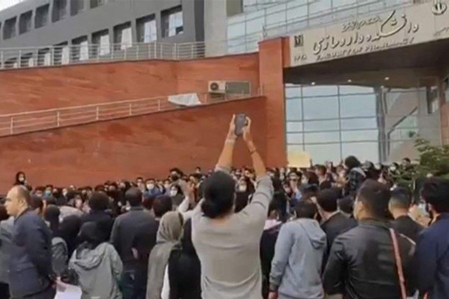 This image grab from a UGC video made available on Twitter reportedly on 22 October 2022 shows students protesting outside the University of Medical Sciences in Iran's northwestern city of Tabriz, as women-led nationwide protests sparked by the death in custody of Mahsa Amini entered the sixth week. (UGC/AFP)