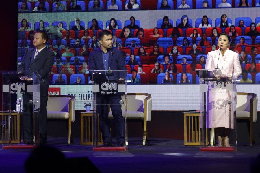 This handout photo taken on 27 February 2022 and received from the Office of the Philippine Vice-President Leni Robredo on 28 February 2022 shows presidential candidates (left to right) Jose Montemayor, Senator Manny Pacquiao and Vice-President Leni Robredo attending a presidential debate in Manila. (Jay Ganzon/Office of the Philippine Vice-President Leni Robredo/AFP)