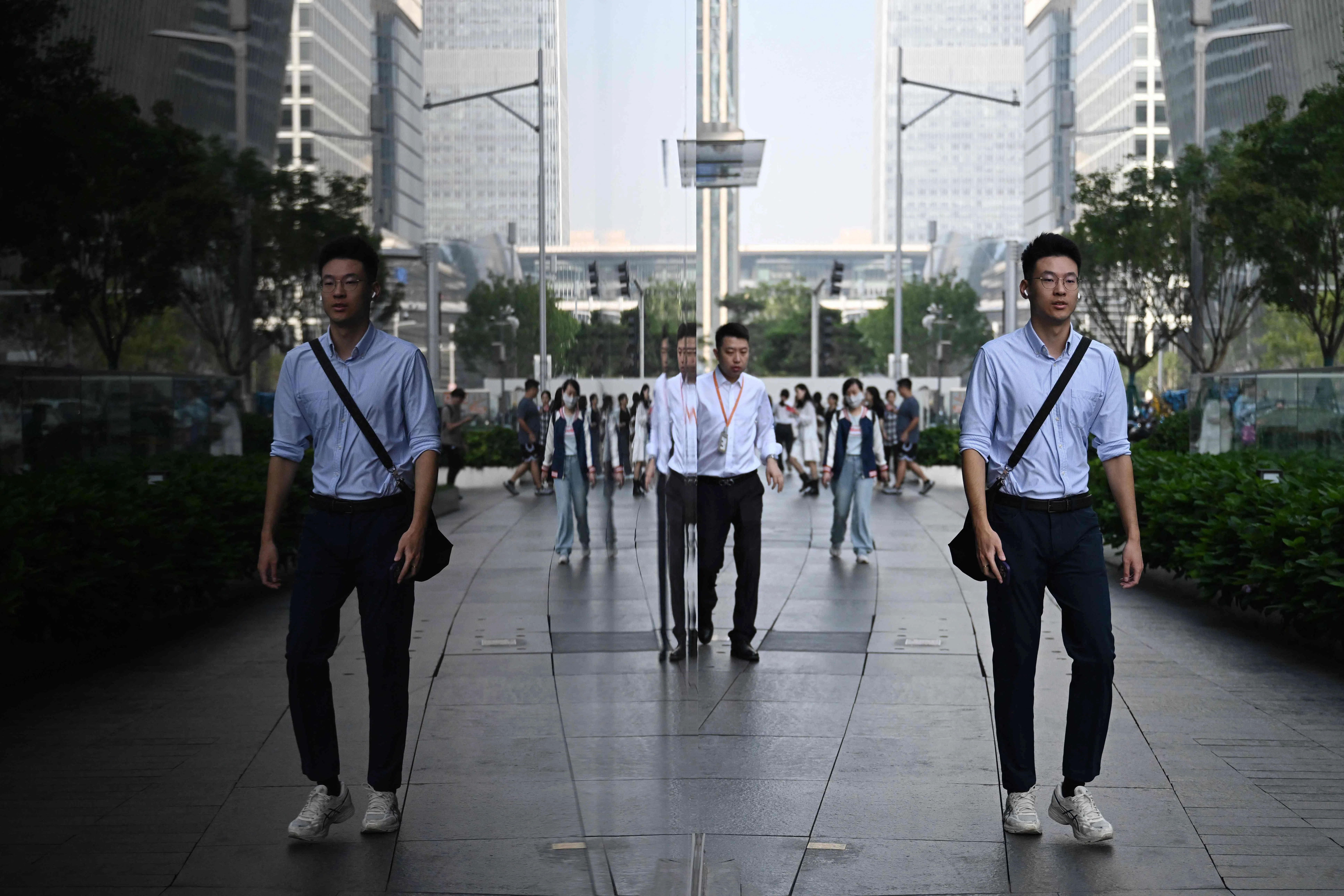 A man walks past an office building in the central business district in Beijing on 23 September 2026.