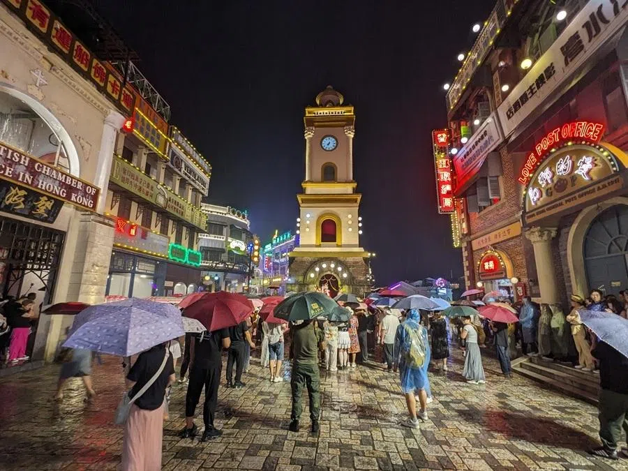Tourists view an old-school film-themed performance at the Guangzhou Street and Hong Kong Street scenic area in Hengdian, a popular shooting location for film crews.
