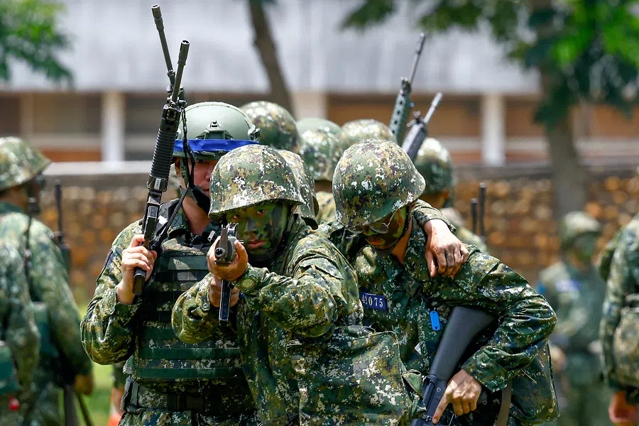 A new military recruit aims a weapon during a training in Taichung, Taiwan, on 28 June 2024. (Ann Wang/Reuters)