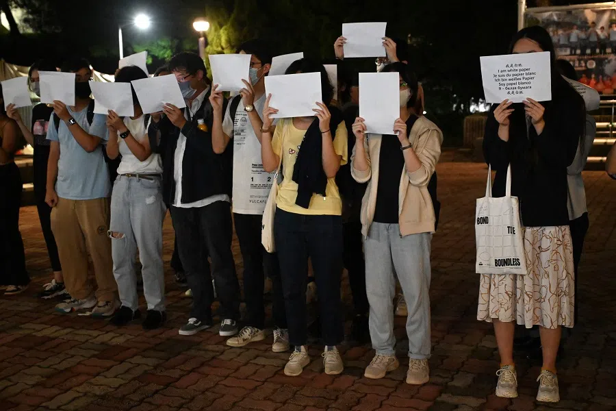 Students hold up placards including white sheets of paper on the campus of the Chinese University of Hong Kong, in solidarity with protests held in the mainland over Beijing's Covid-19 restrictions, in Hong Kong, China, on 28 November 2022. (Peter Parks/AFP)