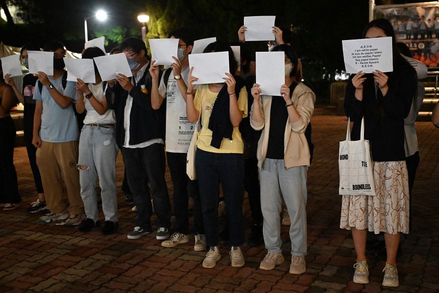 Students hold up placards including white sheets of paper on the campus of the Chinese University of Hong Kong, in solidarity with protests held in the mainland over Beijing's Covid-19 restrictions, in Hong Kong, China, on 28 November 2022. (Peter Parks/AFP)