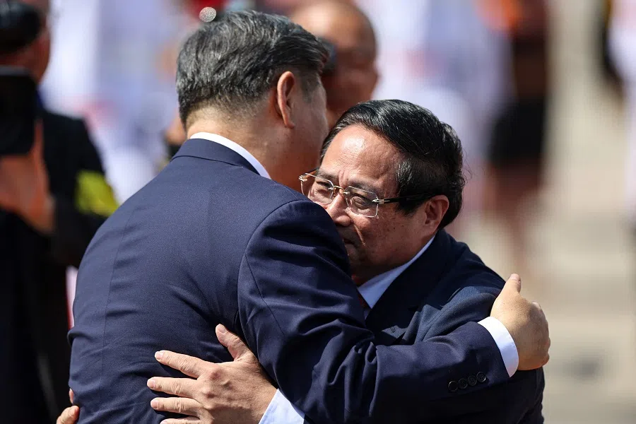 Chinese President Xi Jinping hugs Vietnamese Prime Minister Pham Minh Chinh as he leaves to board his plane for departure following his visit to Vietnam at Noi Bai International Airport in Hanoi on 15 April 2025. (Athit Perawongmetha/AFP)