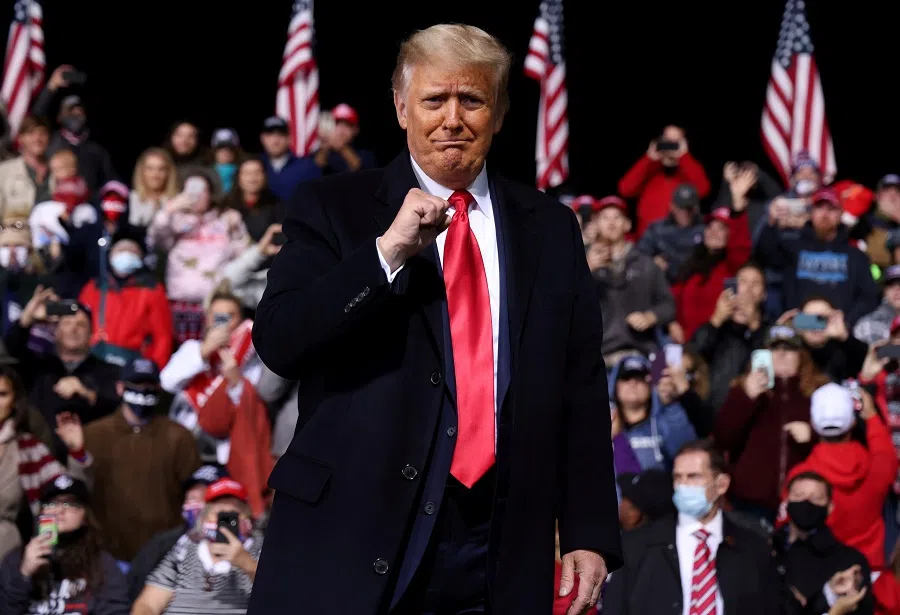 US President Donald Trump gestures as he leaves after a campaign event for Republican US senators David Perdue and Kelly Loeffler in Valdosta, Georgia, US, 5 December 2020. (Jonathan Ernst/Reuters)
