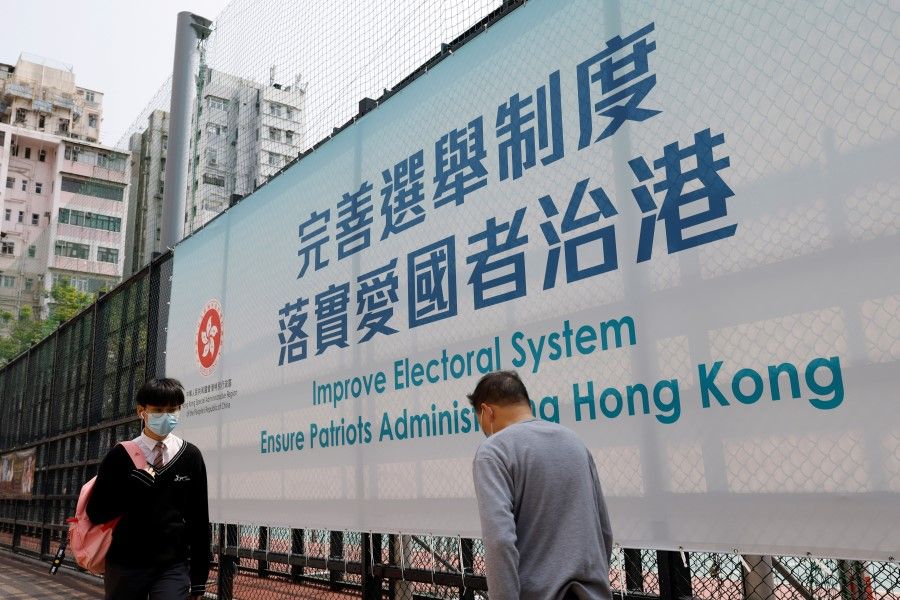 A government advertisement promoting Hong Kong electoral reforms is seen before the Chinese parliament meeting, in Hong Kong, China, 26 March 2021. (Tyrone Siu/Reuters)