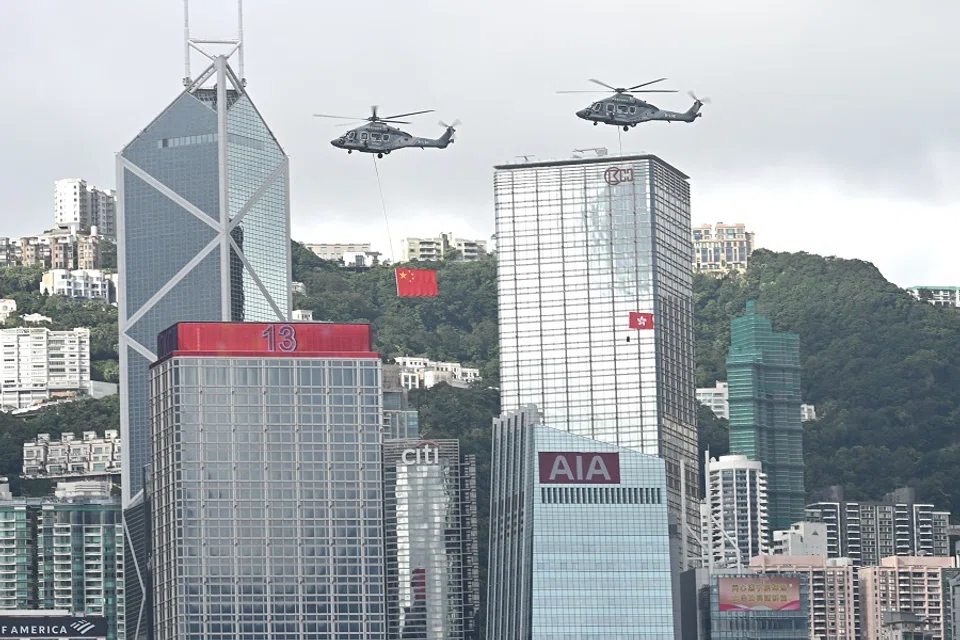 Helicopters fly over Victoria Harbour during a flag-raising ceremony to mark the 28th anniversary of Hong Kong’s handover from Britain to China in Hong Kong on 1 July 2025. (Peter Parks/AFP)