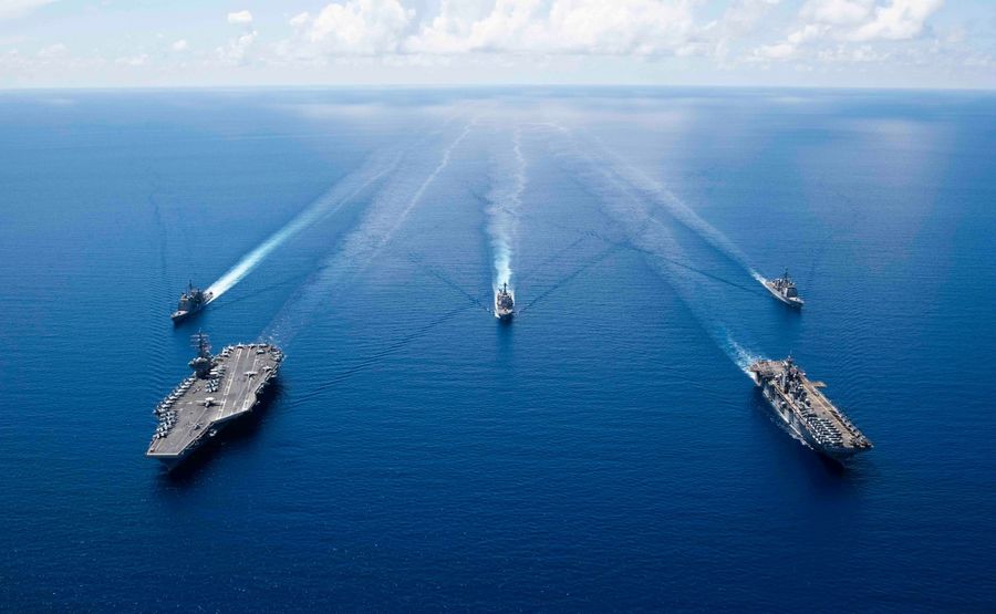 This US Navy photo obtained October 7, 2019 shows the aircraft carrier USS Ronald Reagan (CVN 76)(L), and the amphibious assault ship USS Boxer (LHD 6) and ships from the Ronald Reagan Carrier Strike Group and the Boxer Amphibious Ready Group underway in formation while conducting security and stability operations in the US 7th Fleet area of operations on October 6, 2019 in the South China Sea. (AFP/US Navy/Erwin Jacob V. Miciano/Handout)