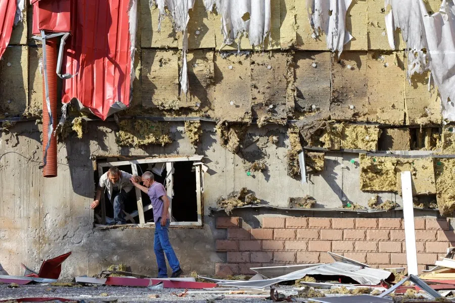 A man gets out of a damaged residential building located in Panfilova street following recent shelling in the course of Ukraine-Russia conflict in Donetsk, Ukraine June 20, 2022. REUTERS/Alexander Ermochenko