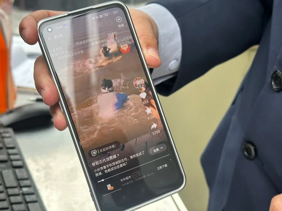 Lin Xiangchun (pseudonym) displays an ultra-short drama that he is watching on his phone. (Photo: Daryl Lim)