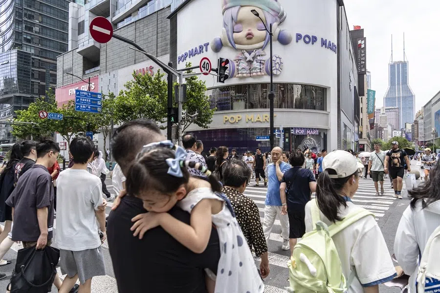 Pedestrians walk down Nanjing Road in Shanghai, China, on 27 July 2024. (Qilai Shen/Bloomberg)