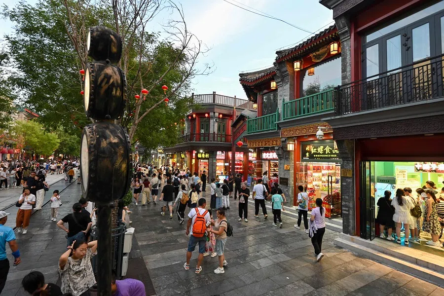 People visit the Qianmen Street in Beijing, China, on 8 August 2024. (Adek Berry/AFP)