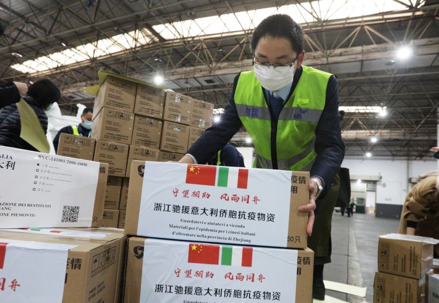 Staff members move medical supplies to be sent to Italy, at a logistics center of the international airport in Hangzhou, March 10, 2020. (China Daily via REUTERS)