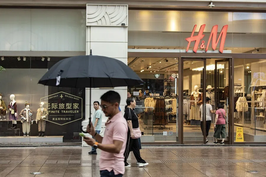 Visitors walk down the main shopping street of Nanjing East Road, one of the city's main commercial and tourist areas, in Shanghai, China, on 30 September 2023. (Qilai Shen/Bloomberg)
