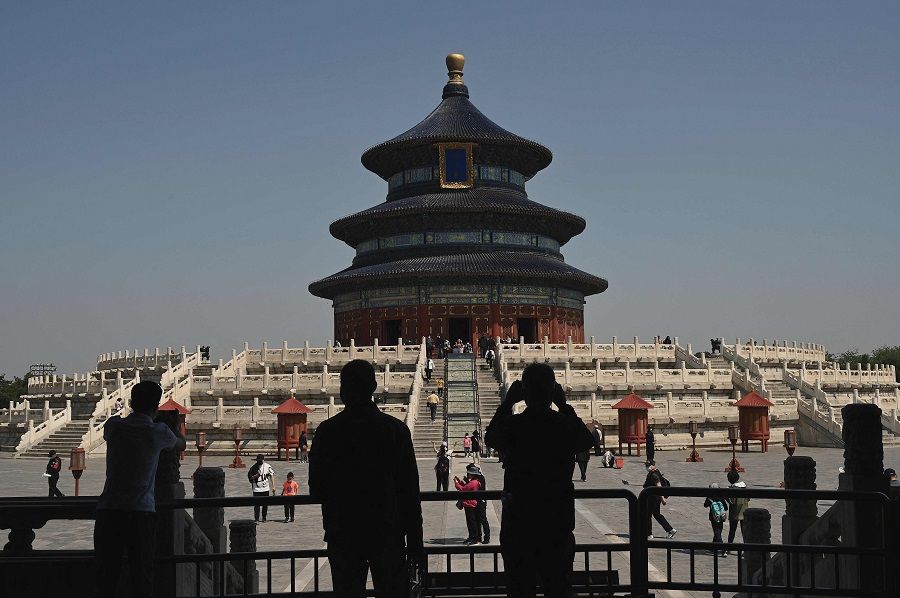 People walk inside the Temple of Heaven in Beijing, China, during the Labour Day holidays on 2 May 2022. (Noel Celis/AFP)