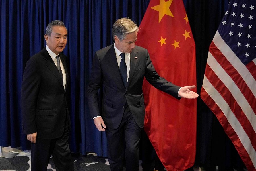 US Secretary of State Antony Blinken (right) shows the way to Director of the Office of the Foreign Affairs Commission of the Communist Party of China's Central Committee Wang Yi during their bilateral meeting on the sidelines of the Association of Southeast Asian Nations (ASEAN) Foreign Ministers' Meeting in Jakarta, Indonesia, on 13 July 2023. (Dita Alangkara/Pool/AFP)