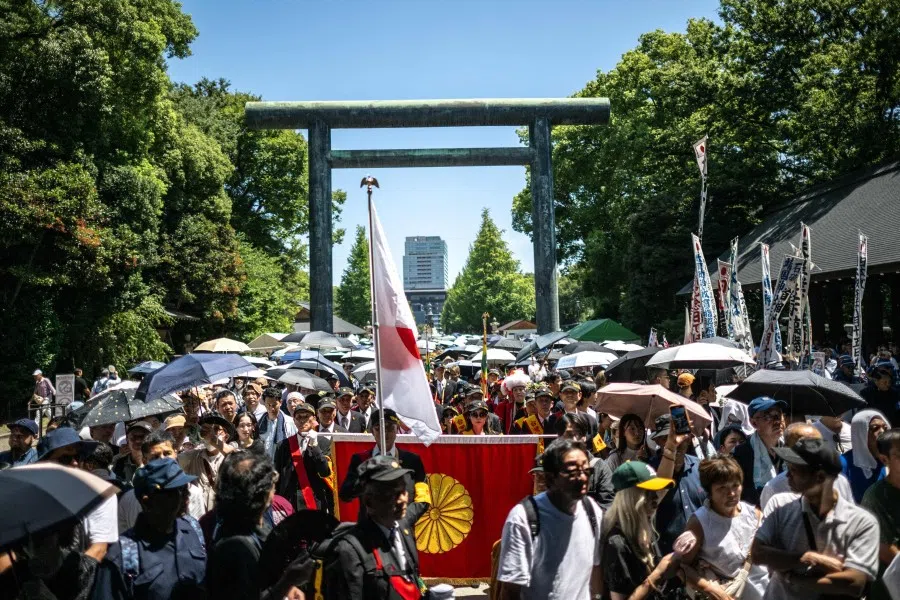 A group called “Taiwan Civil Government” queues with others to pay their respects during a visit to the Yasukuni Shrine in Tokyo on 15 August 2025, on the 80th anniversary of Japan’s surrender in World War II. (Philip Fong/AFP)