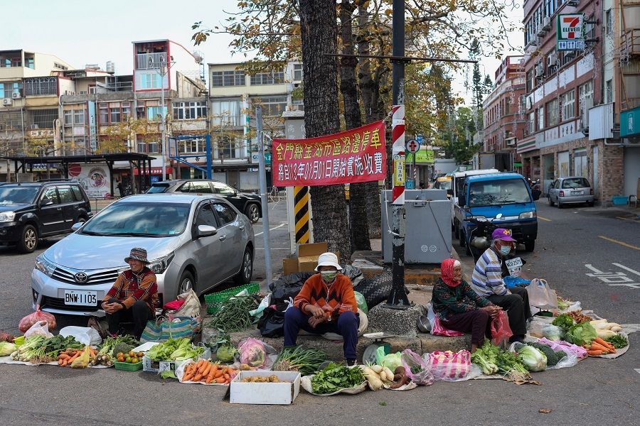 Fruits and vegetable sellers sit at a morning market in Kinmen, Taiwan, on 21 February 2024. (Ann Wang/Reuters)
