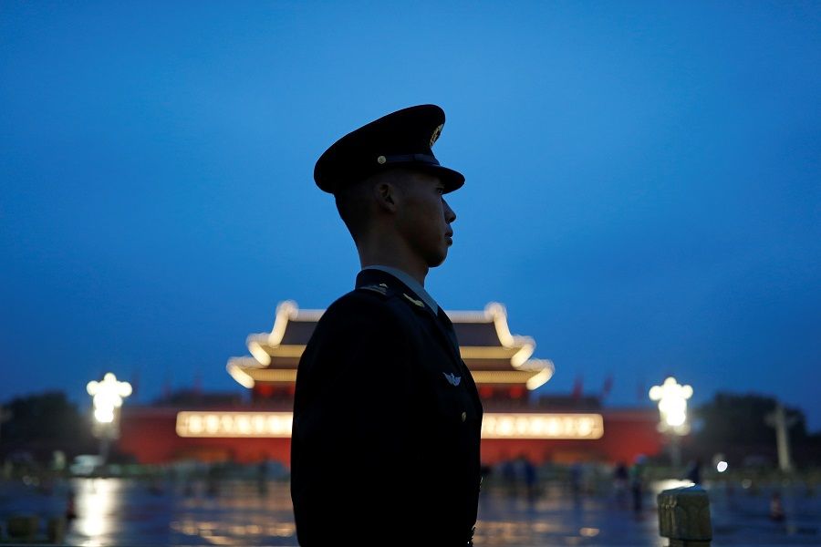 A paramilitary police officer stands guard during a flag-raising ceremony at Tiananmen Square on National Day to mark the 71st anniversary of the founding of People's Republic of China, in Beijing, China, 1 October 2020. (Carlos Garcia Rawlins/Reuters)