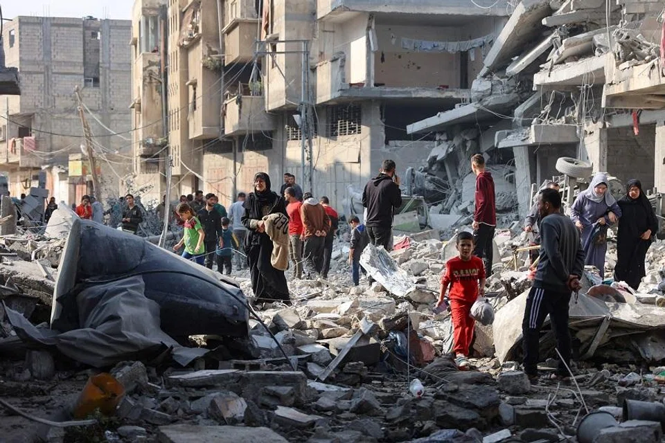 Palestinians walk amid the destruction following an Israeli strike in Jabalia in the northern Gaza Strip on 10 November 2024. Israel’s military has been conducting a sweeping air and ground assault in northern Gaza since 6 October 2024, particularly around Jabalia, Beit Lahia and Beit Hanoun, saying it aims to prevent Hamas regrouping. (Omar Al-Qattaa/AFP)