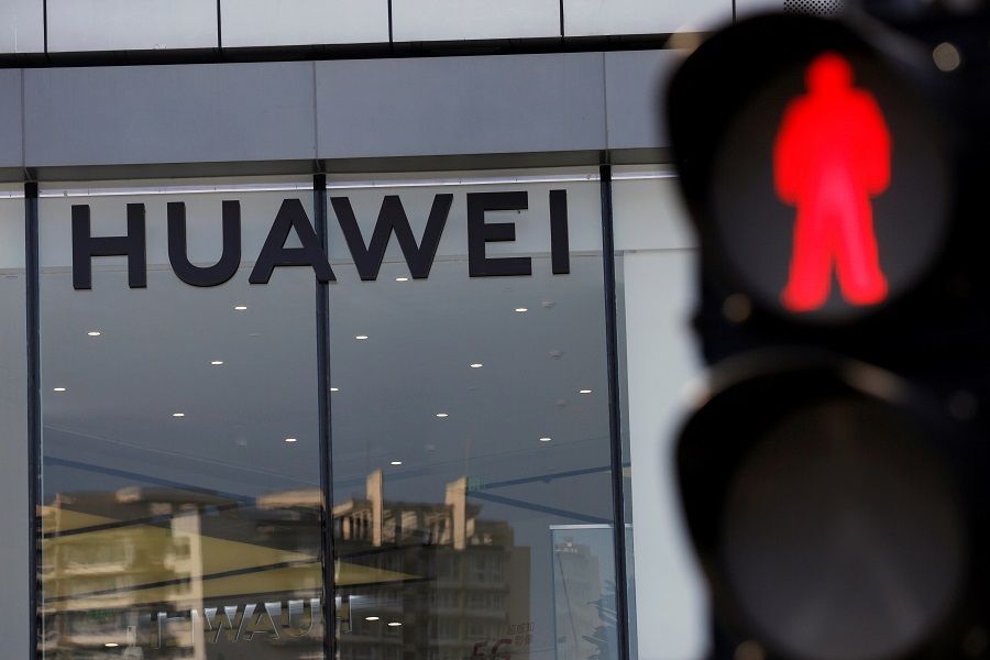 A Huawei sign is seen on its store near a traffic light in Beijing, China, on 14 July 2020. (Tingshu Wang/File Photo/Reuters)
