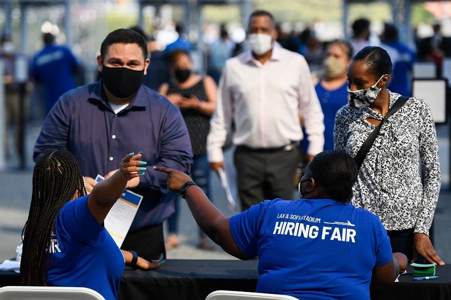 People receive information as they attend a job fair for employment with SoFi Stadium and Los Angeles International Airport employers, at SoFi Stadium on September 9, 2021, in Inglewood, California, US. (Patrick T. Fallon/AFP)