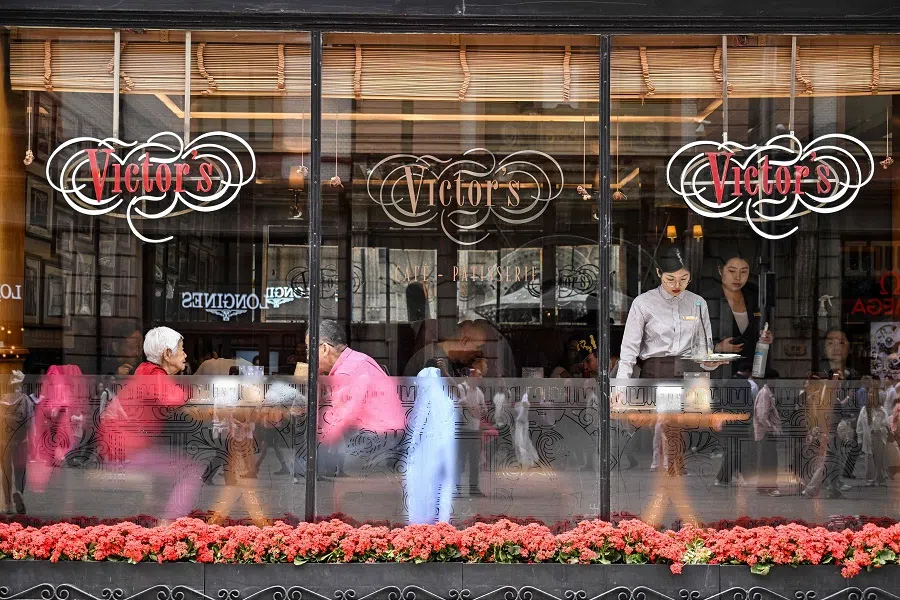 People are seen in a restaurant in the Huangpu district in Shanghai on 11 April 2025. (Hector Retamal/AFP)