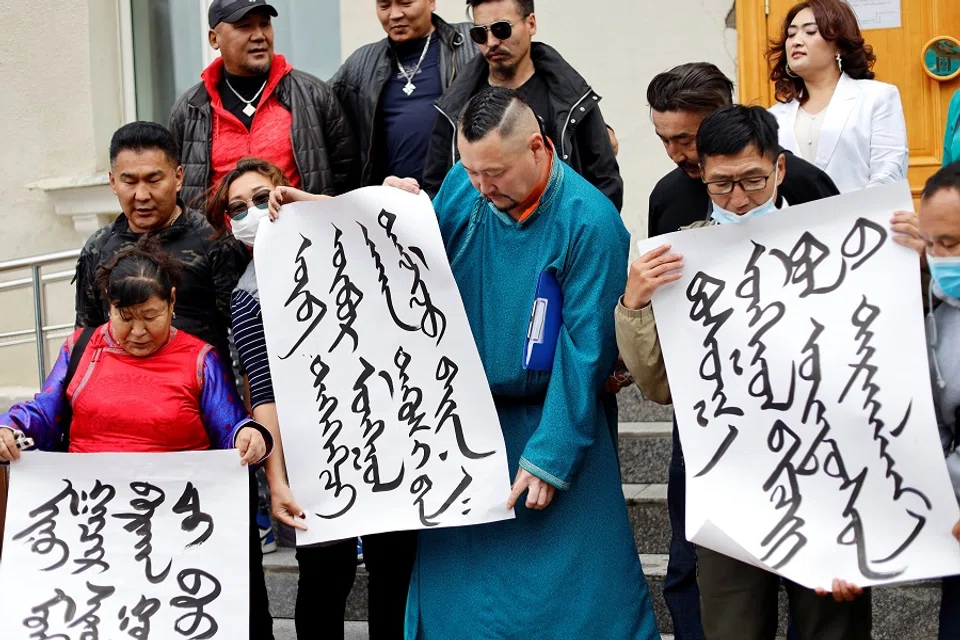 Demonstrators, holding signs with Mongolian script, protest against China's changes to school curriculums that remove Mongolian language from core subjects, outside the Mongolian Ministry of Foreign Affairs in Ulaanbaatar, Mongolia, 31 August 2020. (Anand Tumurtogoo/Reuters)