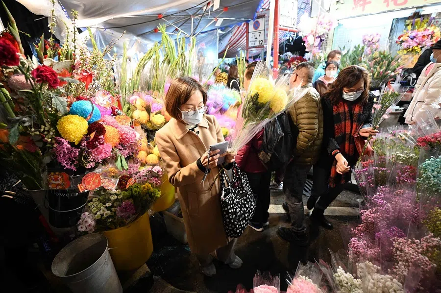 People shop for flowers at the Mongkok flower market in Hong Kong on 9 February 2024. (Peter Parks/AFP)